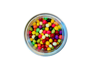 Directly above shot of multi colored candies against white background