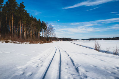 Snow covered field against sky