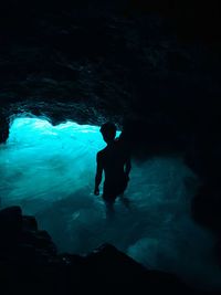 Silhouette man swimming in sea