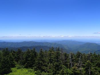 Scenic view of mountains against clear blue sky