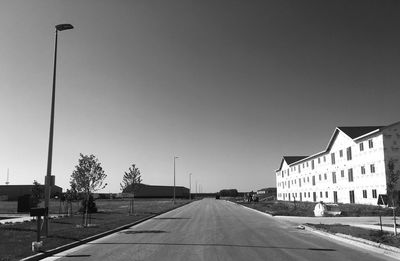 Empty road along buildings