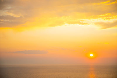 Scenic view of sea against romantic sky at sunset