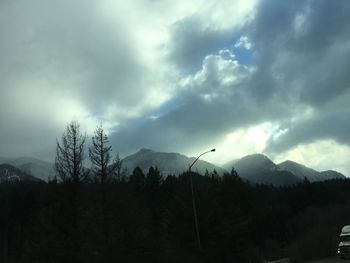 Scenic view of mountains against cloudy sky