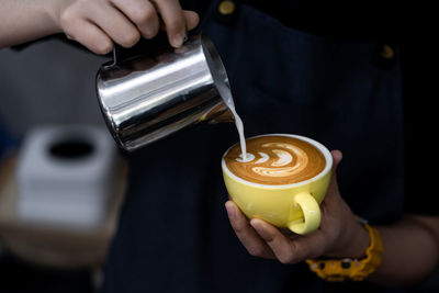 Cropped image of person making coffee