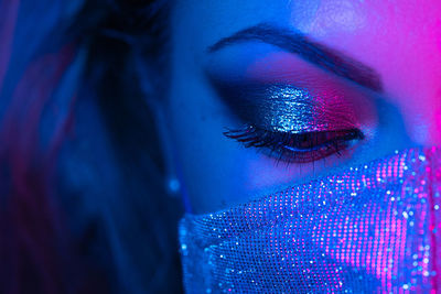 Close-up of illuminated woman face with make up