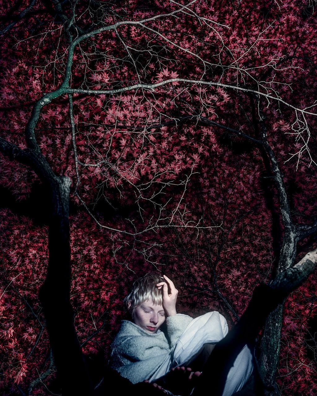 PORTRAIT OF YOUNG WOMAN WITH RED LEAVES