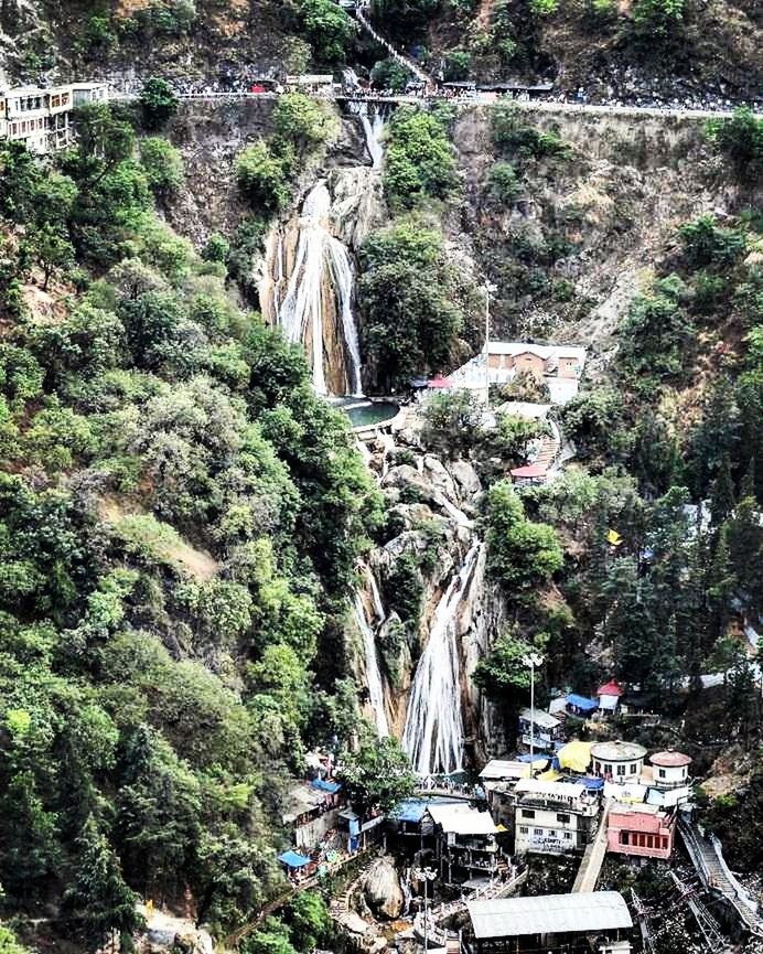 VIEW OF WATERFALL WITH TREES IN BACKGROUND