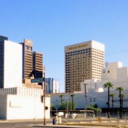 Buildings in city against blue sky