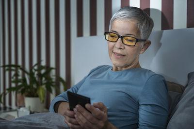 Portrait of mature man using mobile phone