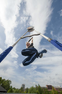 Low angle view of man standing on field against sky