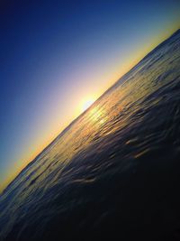 Scenic view of sea against clear sky at sunset