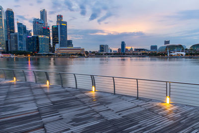 Business buildings shining beams of light at night time around marina bay