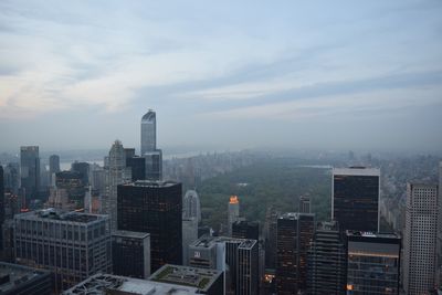 Cityscape against cloudy sky