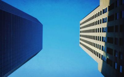 Low angle view of buildings against clear blue sky