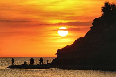 Scenic view of sea against orange sky