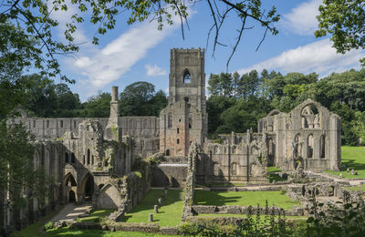 Ruins of temple against cloudy sky