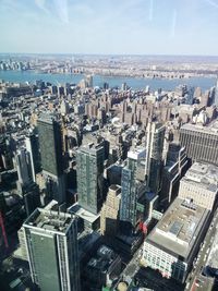 High angle view of modern buildings in city against sky