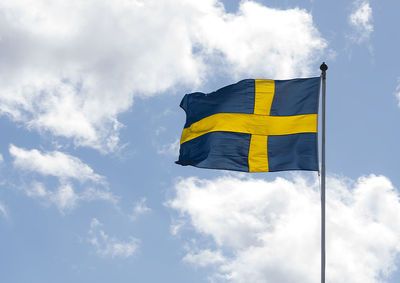 Low angle view of flag against sky