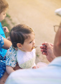 Midsection of mother and daughter while holding hands