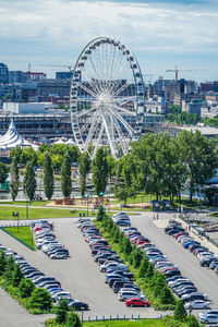 High angle view of ferris wheel in city against sky