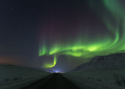 Scenic view of aurora borealis against sky at night