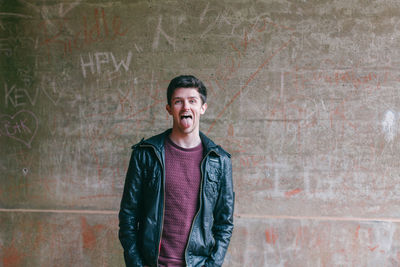 Portrait of smiling young man standing outdoors