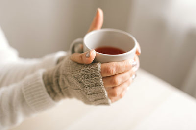 Close-up of hand holding tea cup