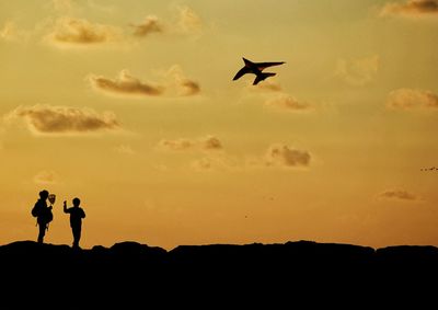 Silhouette of woman at sunset