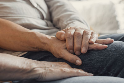 Low section of man holding hands