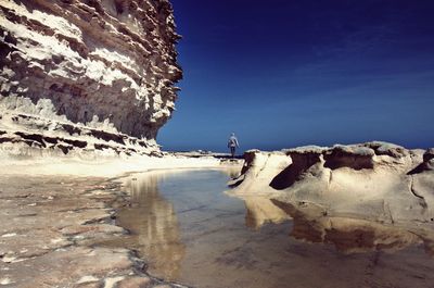 Scenic view of beach against clear sky during winter