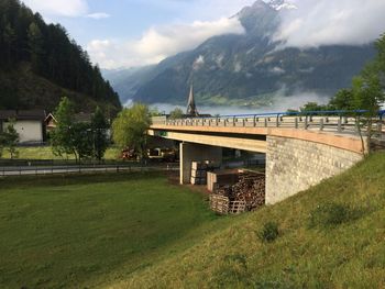 Scenic view of bridge over mountains against sky