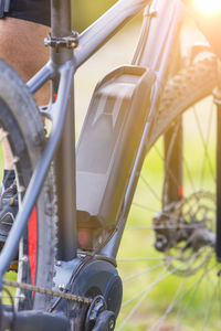 Low section of man riding bicycle at park