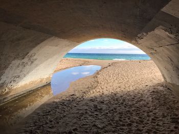 Scenic view of sea seen through tunnel