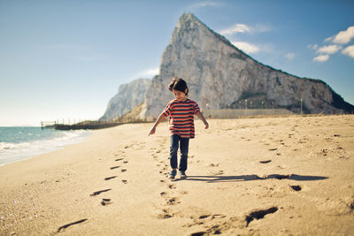 Boy walking on beach