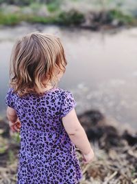 Rear view of woman standing on land