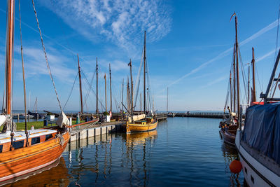 Sailboats moored in marina