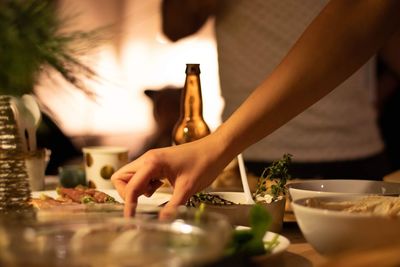 Cropped hand of person preparing food at home