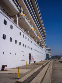 Low angle view of big cruise ship against clear blue sky
