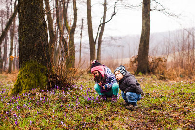 Father with daughter against trees