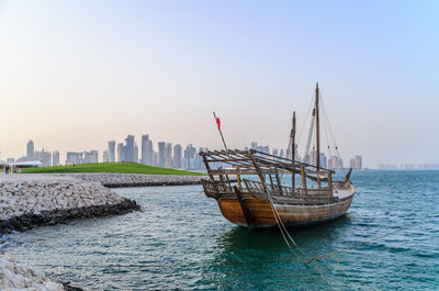 Traditional dhow moored near the museum of islamic art doha, qatar. 