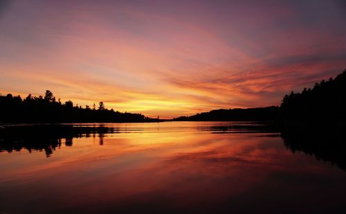 Scenic view of lake at sunset