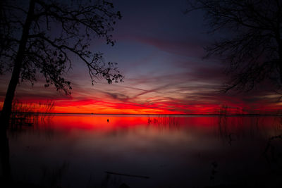 Scenic view of lake against romantic sky at sunset