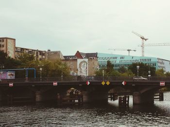 Bridge over river with buildings in background