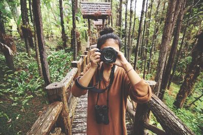 Woman standing in forest