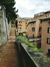 Alley amidst buildings against sky