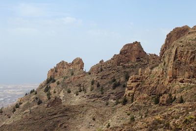 Rock formations on landscape against sky