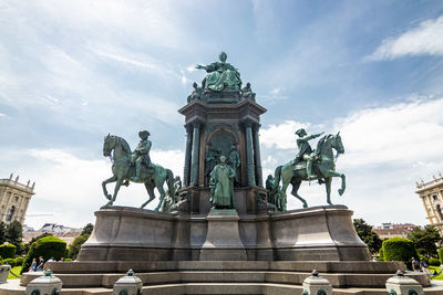 Low angle view of statue against cloudy sky