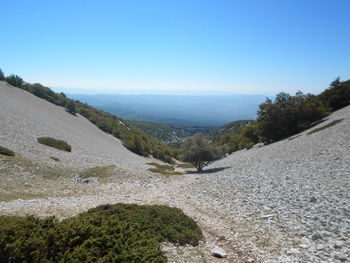 Scenic view of mountain range against clear blue sky