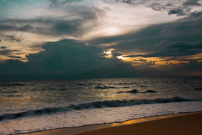 Scenic view of beach against sky during sunset