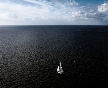 Sailboat in sea against sky